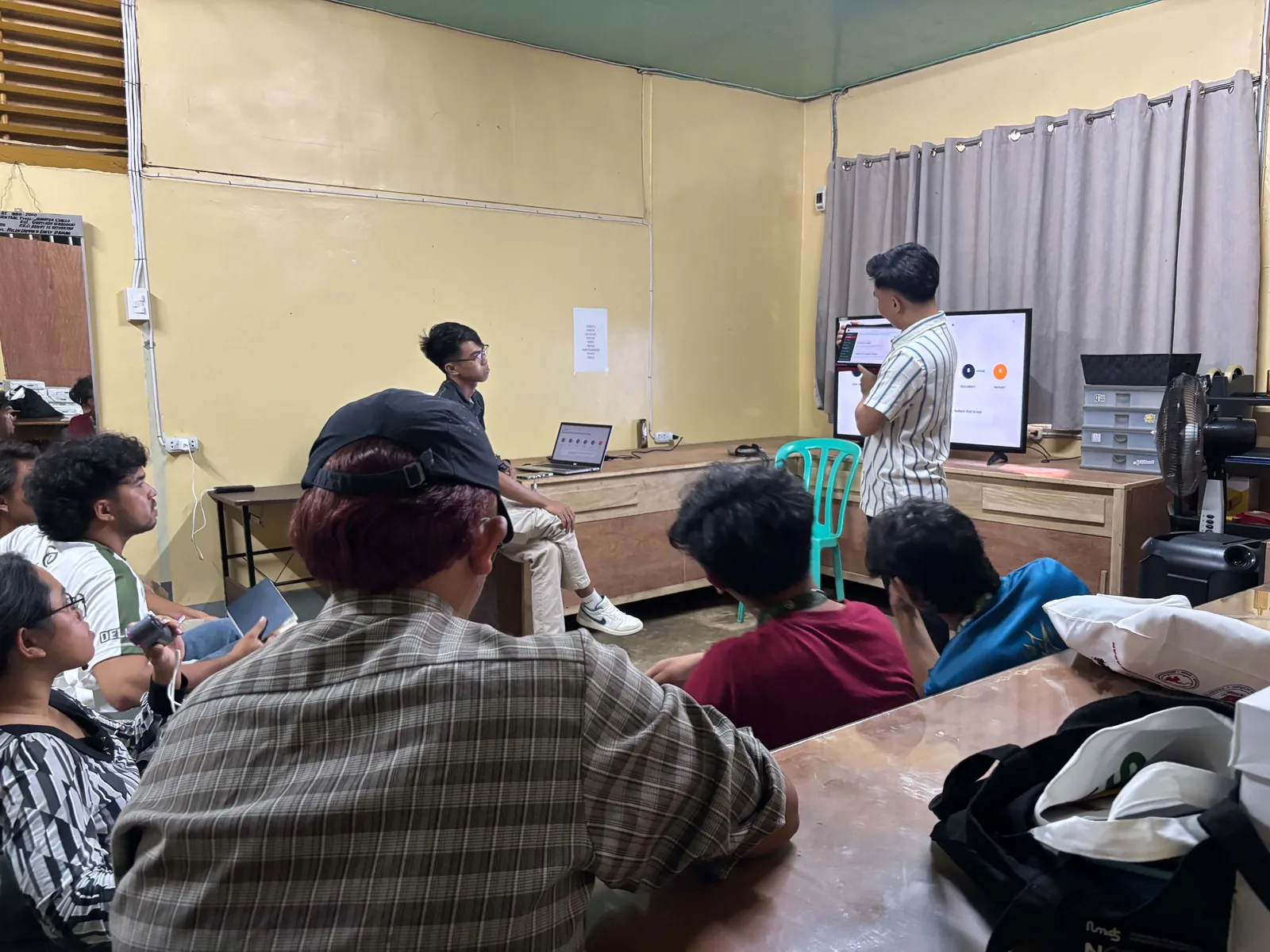 CampusFlow presenter demonstrating the product on a monitor to seated council participants